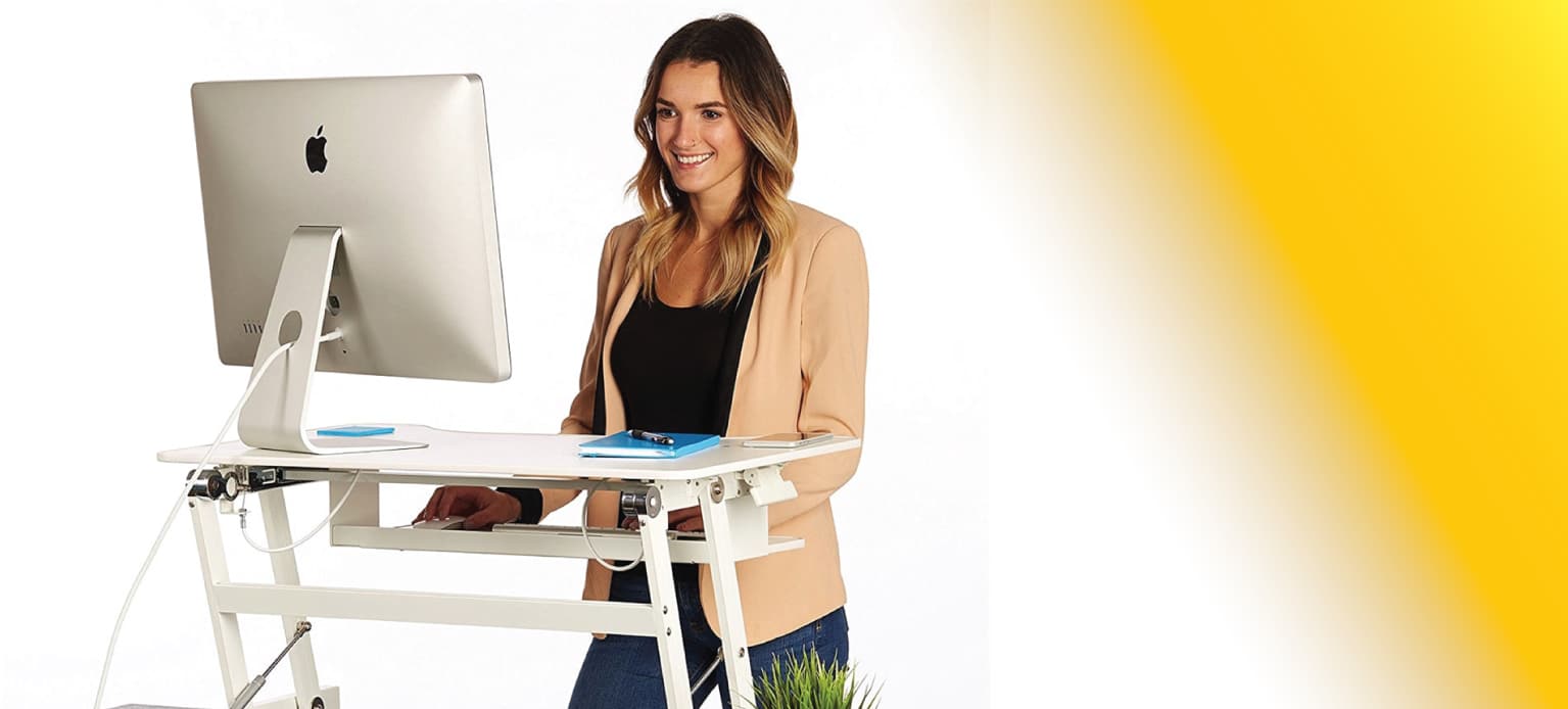 The advantages of standing desks as woman works behind a standing desk.